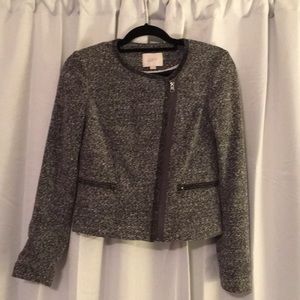 Light grey jacket/sweater with side zipper.